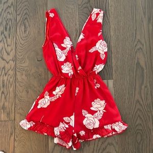 Red with white floral sleeveless romper.